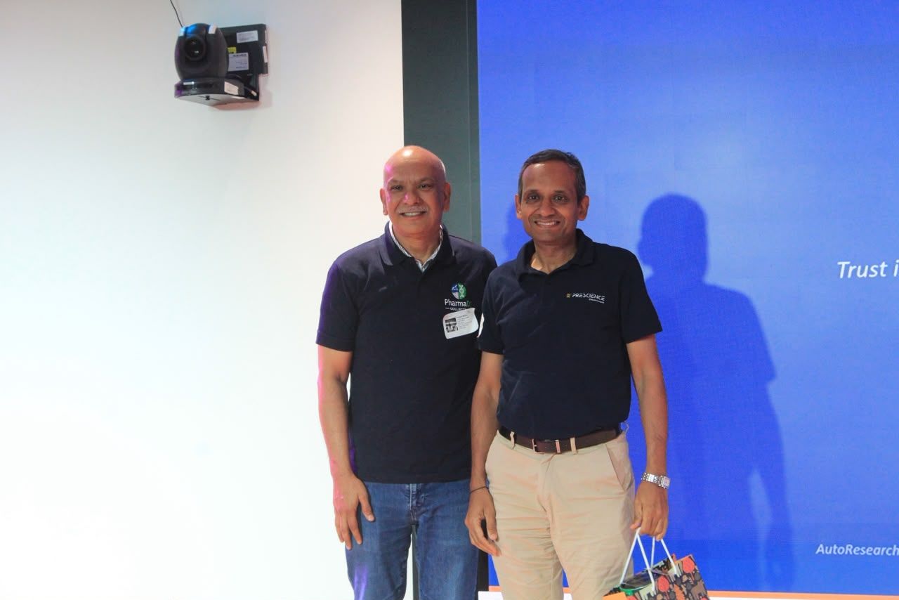 A speaker being felicitated on stage by a member of the PharmaDS Collective.